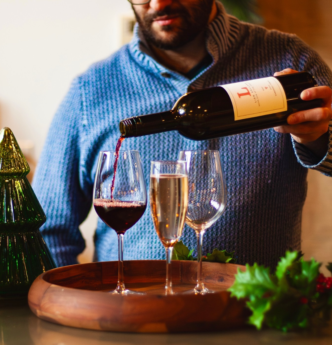 Zach pouring wine at a private tasting